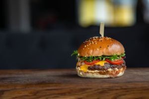 fresh burger on a wooden counter top