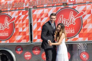 A newlywed couple in front of our food truck.