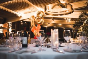Birthday party for 18 year old with white tablecloths and wine on the table catered by Aioli with winder birthday party food ideas.