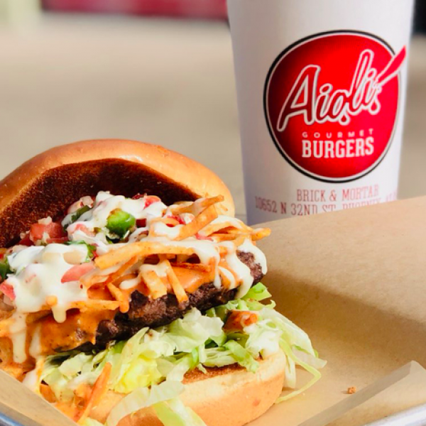 Large cheese burger and drink at aioli burger